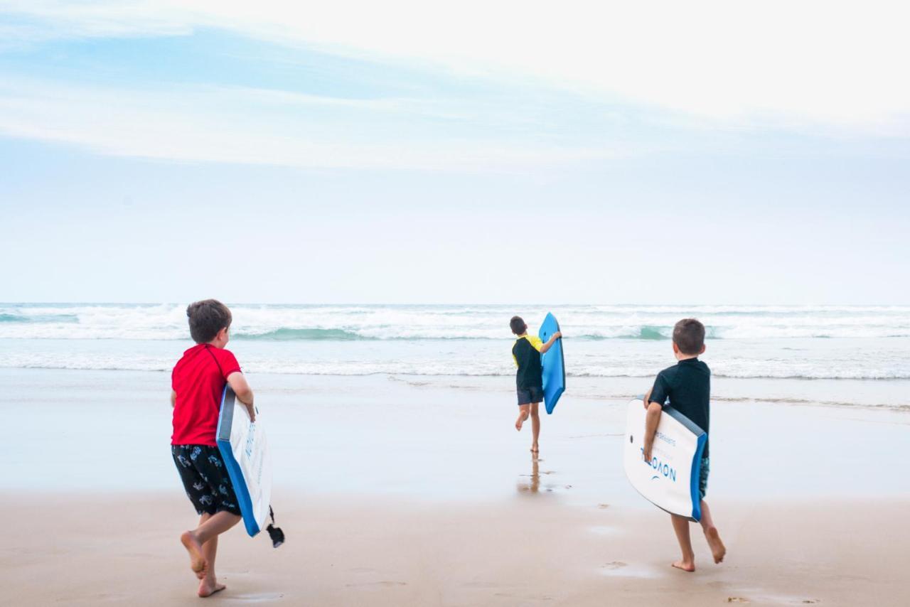 Novotel Chennai Sipcot Εξωτερικό φωτογραφία Children learning to surf at the beach